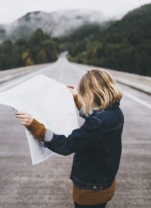 This is an image of a woman looking at a map